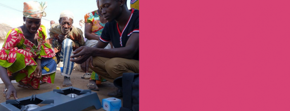 Women in Ghana demonstrates a clean cookstove